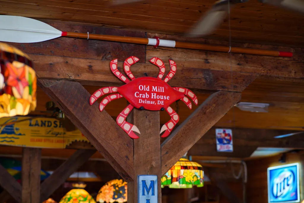 a crab shaped sign hanging from the ceiling