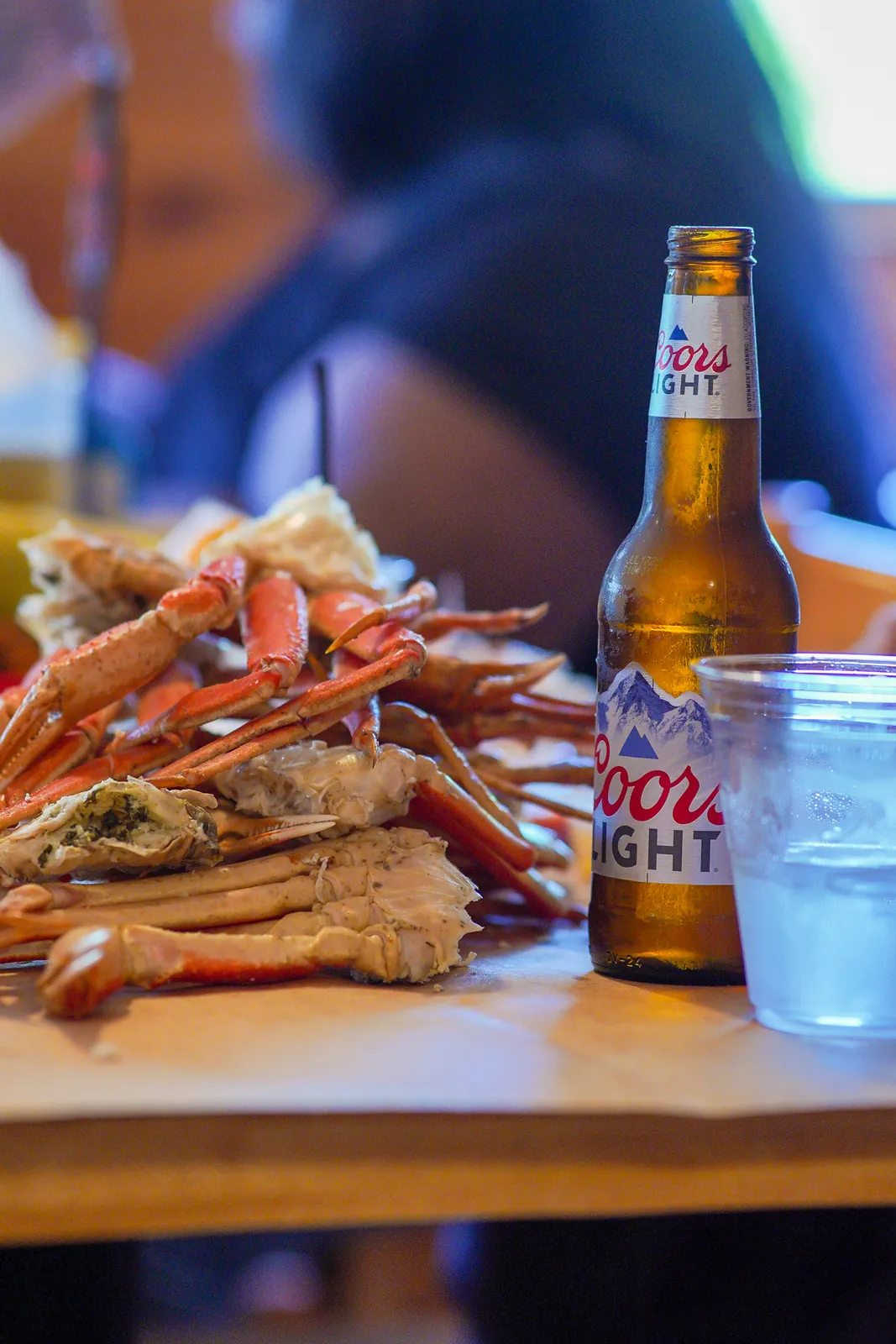 a plate of lobsters and beer on a table