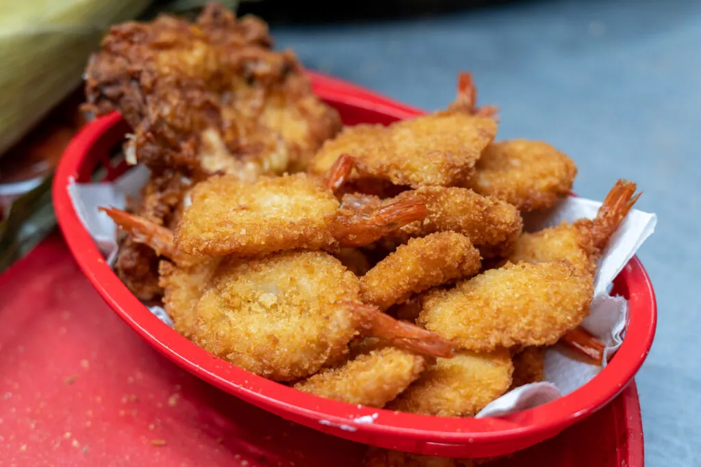 a red bowl filled with fried food on top of a table