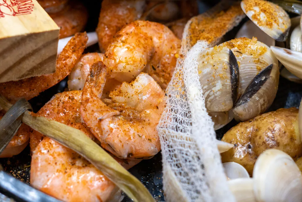 shrimp, clams, and other seafood are in a basket